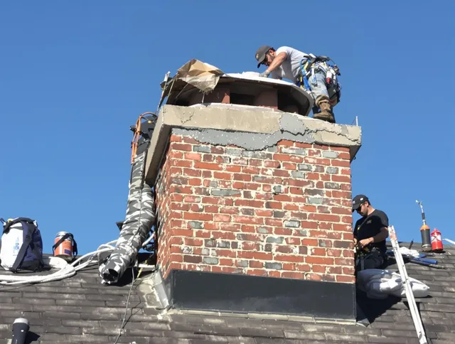 Ashland Chimney Sweep installing a custom chimney crown in Ashland, MA
