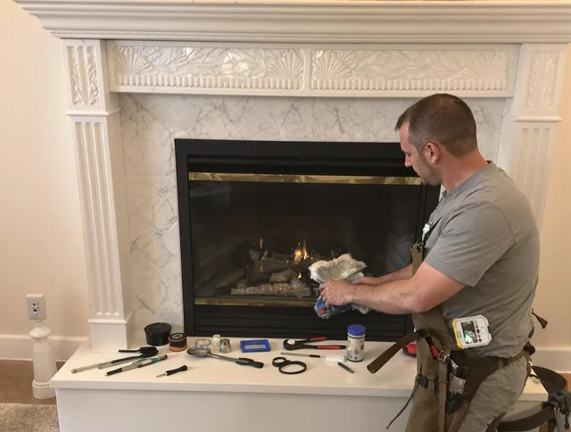 Ashland Chimney Sweep performing fireplace maintenance in Ashland, MA