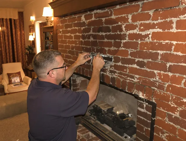 Ashland Chimney Sweep expert fixing a fireplace in Ashland, MA